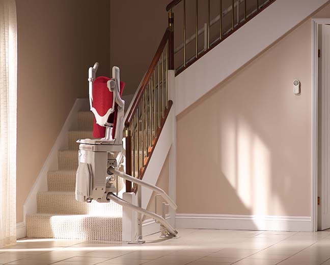 stairlift climbing a curved stair rail